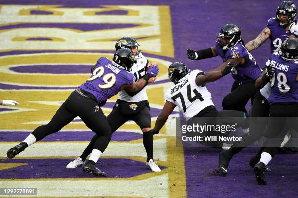 Quarterback Gardner Minshew II of the Jacksonville Jaguars is sacked by linebacker Matthew Judon of the Baltimore Ravens in the end zone for a safety...