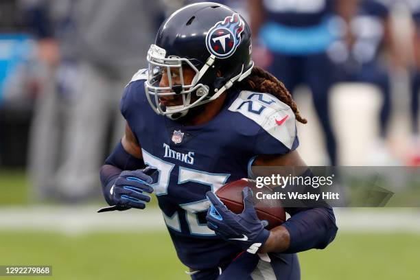 Running back Derrick Henry of the Tennessee Titans caries the football against the defense of the Detroit Lions during the first quarter of the game...