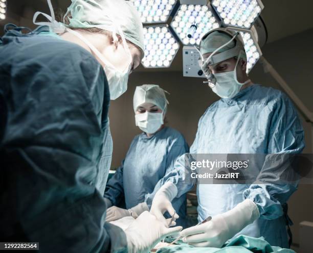 micro surgery with surgery robot - neurosurgery stock pictures, royalty-free photos & images