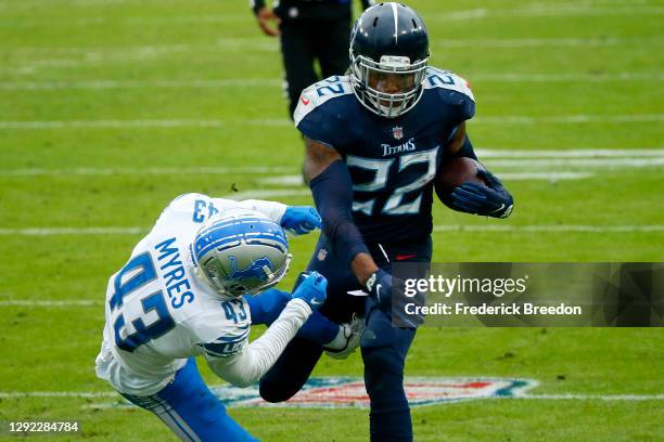 Running back Derrick Henry of the Tennessee Titans stiff arms cornerback Alexander Myers#43 of the Detroit Lions during the second quarter of the...