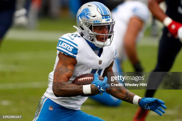 Wide receiver Marvin Jones of the Detroit Lions carries the football against the defense of the Tennessee Titans during the second quarter of the...