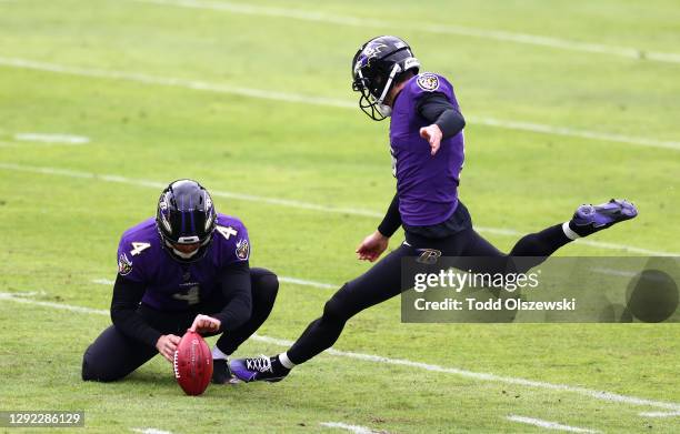 Place kicker Justin Tucker of the Baltimore Ravens attempts an extra point following a touchdown during the first quarter of their game against the...