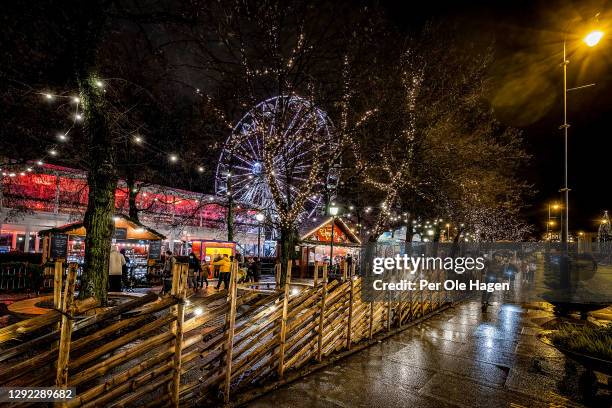 Lights shine at The Karl Johan Street with a Ferris Wheel in Oslo Center on December 20, 2020 in Oslo, Norway.