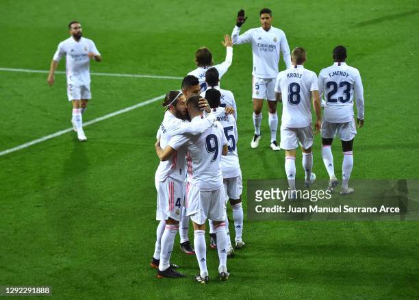Karim Benzema of Real Madrid celebrates with Sergio Ramos and teammates after scoring their team's first goal during the La Liga Santander match...
