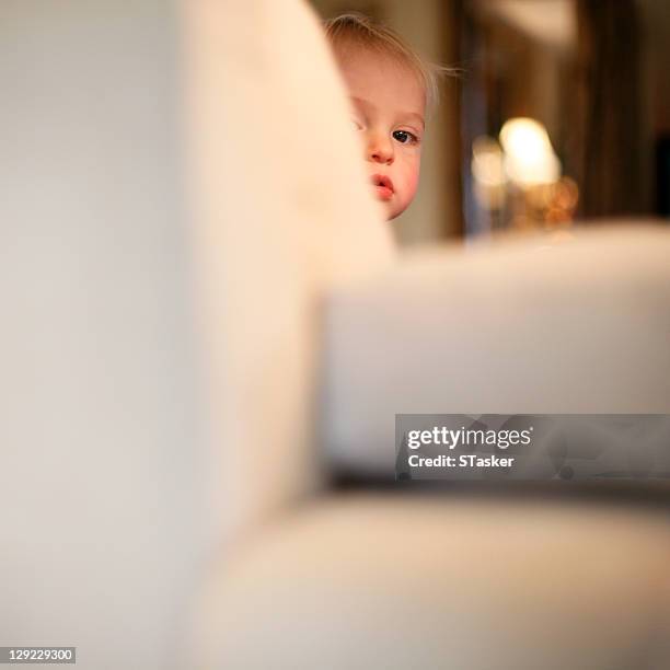boy behind sofa - one baby boy only fotografías e imágenes de stock