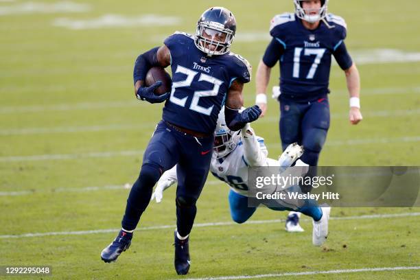 Running back Derrick Henry of the Tennessee Titans carries the football over strong safety Duron Harmon of the Detroit Lions during the game at...