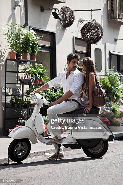 young couple in turin, italy. - riding vespa stock pictures, royalty-free photos & images
