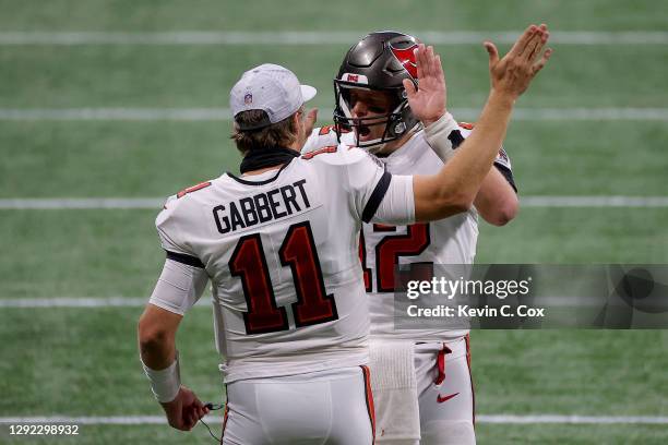 Tom Brady of the Tampa Bay Buccaneers celebrates with Blaine Gabbert after a first down against the Atlanta Falcons during the fourth quarter in the...