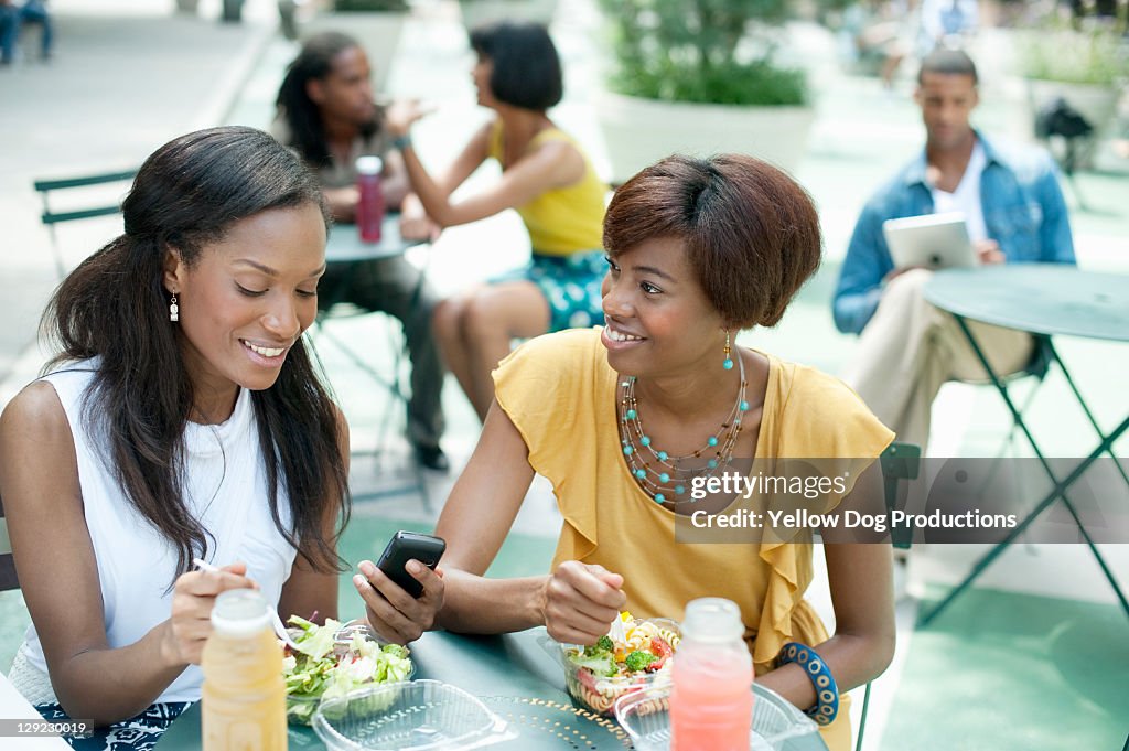 Two Women Friends Eating at Outdoor Cafe