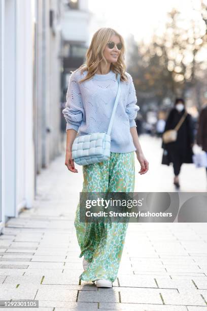 Influencer Gitta Banko wearing a lavender colored knitted pullover by Delicatelove, a light green and yellow maxi silk skirt with leopard print by...