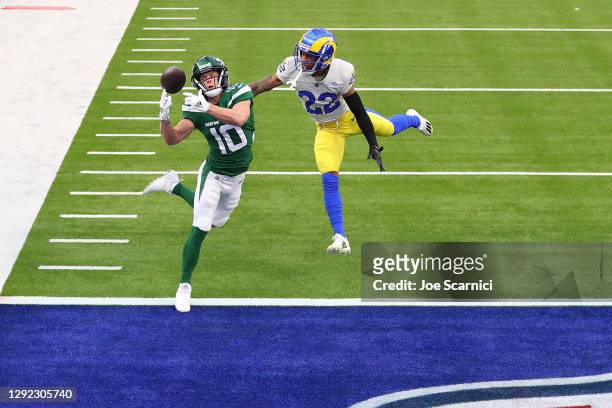 Braxton Berrios of the New York Jets unable to make a catch ahead of defender Troy Hill of the Los Angeles Rams during the second quarter of a game...