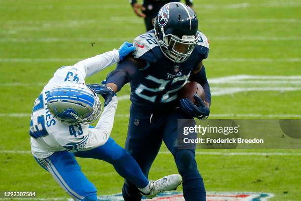 Running back Derrick Henry of the Tennessee Titans stiff arms cornerback Alexander Myers#43 of the Detroit Lions during the second quarter of the...