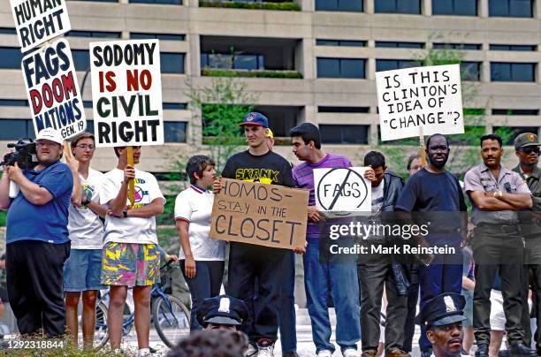 Members of the Westboro Baptist Church from Topeka Kansas holding racist, hate, homophobic, signs protesting at the Lesbian and Gay March on...