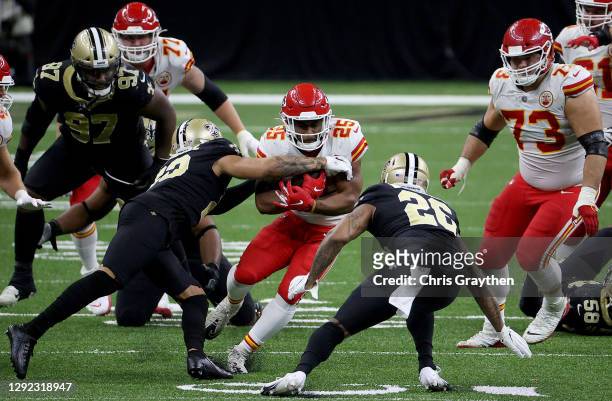 Clyde Edwards-Helaire of the Kansas City Chiefs is stopped by Marshon Lattimore of the New Orleans Saints during the fourth quarter in the game at...