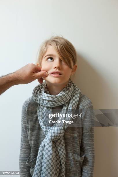 girl being pinched on the cheek by dad - つねる ストックフォトと画像