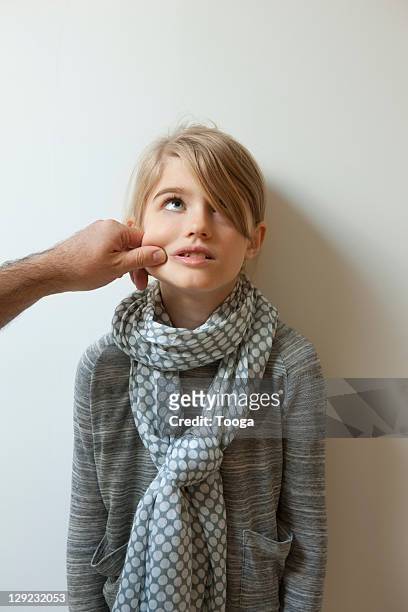girl being pinched on the cheek by dad - pinching stock pictures, royalty-free photos & images