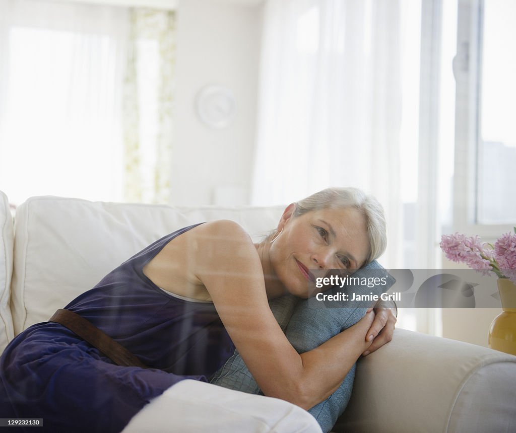 Senior woman looking out window