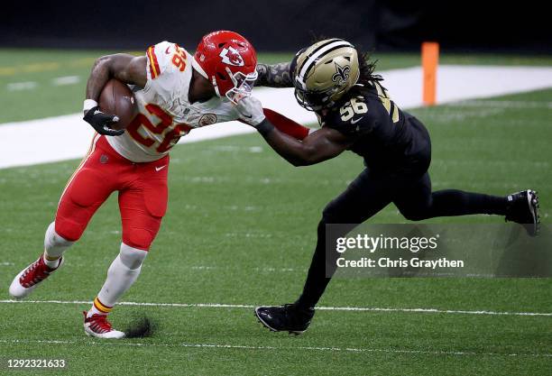 Demario Davis of the New Orleans Saints grabs the face mask of Le'Veon Bell of the Kansas City Chiefs during the fourth quarter in the game at...