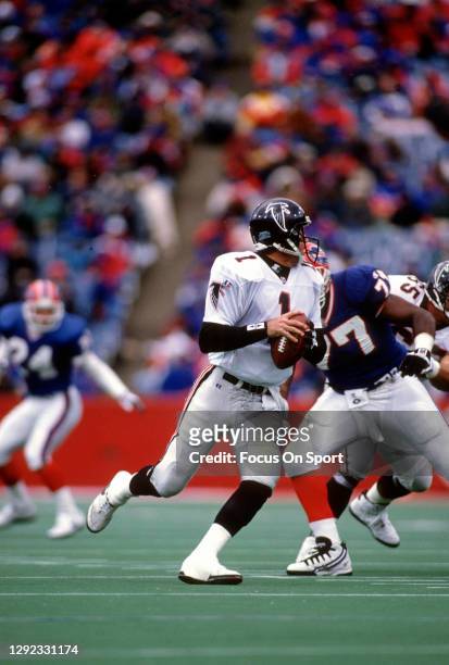 Jeff George of the Atlanta Falcons drops back to pass against the Buffalo Bills during an NFL football game November 12, 1995 at Rich Stadium in...