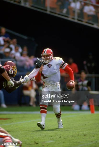 Jeff George of the Atlanta Falcons looks to scramble away from the pressure against the Washington Redskins during an NFL football game September 25,...