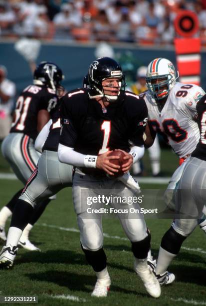 Jeff George of the Atlanta Falcons drops back to pass against the Miami Dolphins during an NFL football game December 3, 1995 at Joe Robbie Stadium...