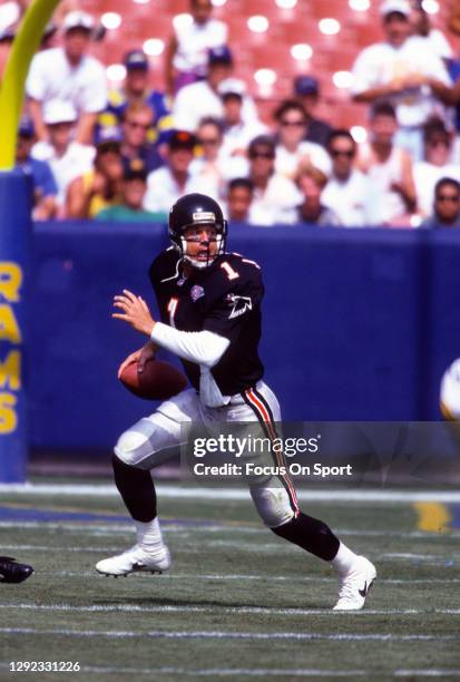 Jeff George of the Atlanta Falcons scrambles looking to pass against the Los Angeles Rams during an NFL football game October 2, 1994 at Anaheim...