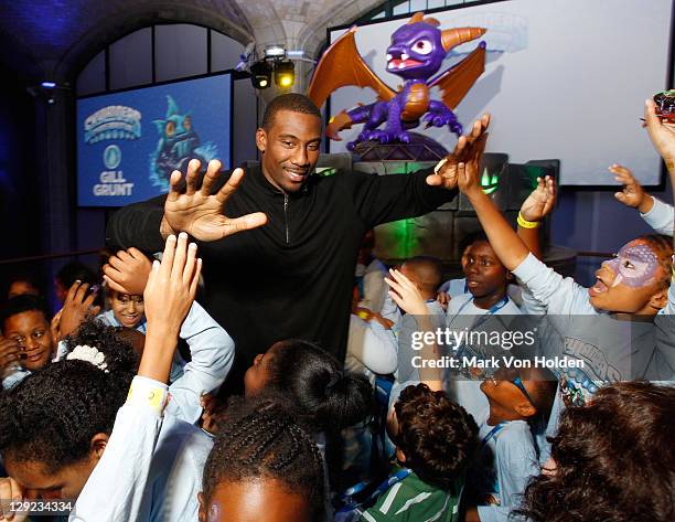 Basketball Player Amar'e Stoudemire poses with members from the Boys and Girls Club at Skylanders Spyro's Adventure Launch Event hosted by Amar'e...