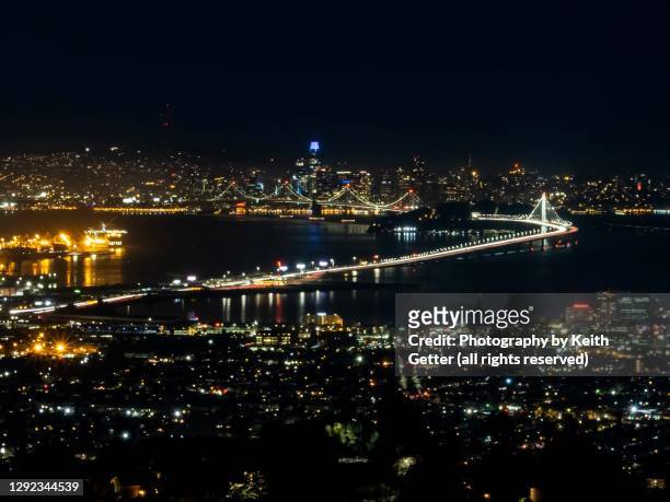 aerial view san francisco -oakland bay bridge at night - oakland california night stock pictures, royalty-free photos & images