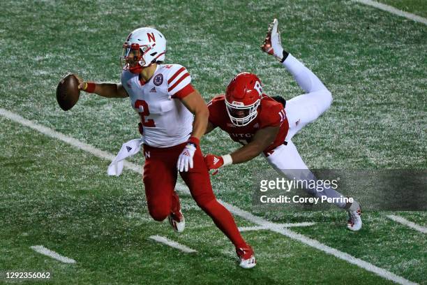 Adrian Martinez of the Nebraska Cornhuskers is able to get off a pass against Drew Singleton of the Rutgers Scarlet Knights during the second quarter...