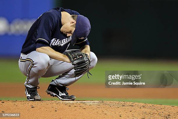 Zack Greinke of the Milwaukee Brewers crouches on the mond against the St. Louis Cardinals during Game Five of the National League Championship...