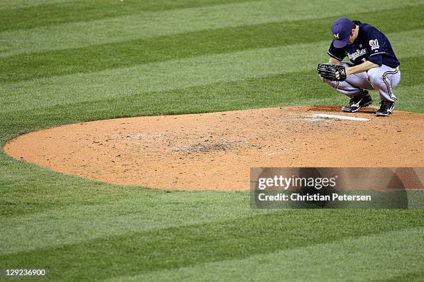 Zack Greinke of the Milwaukee Brewers crouches on the mond against the St. Louis Cardinals during Game Five of the National League Championship...