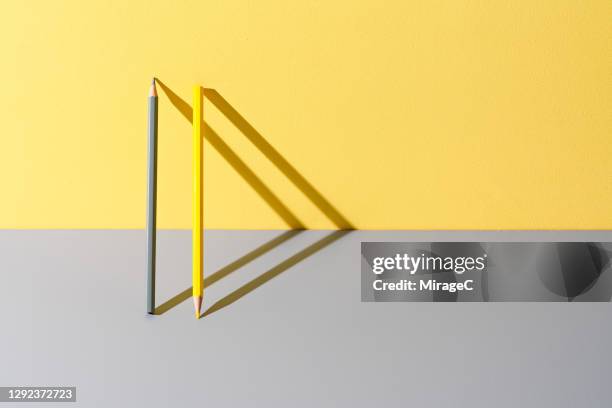 yellow and gray pencils leaning on yellow and gray - parallel stock pictures, royalty-free photos & images