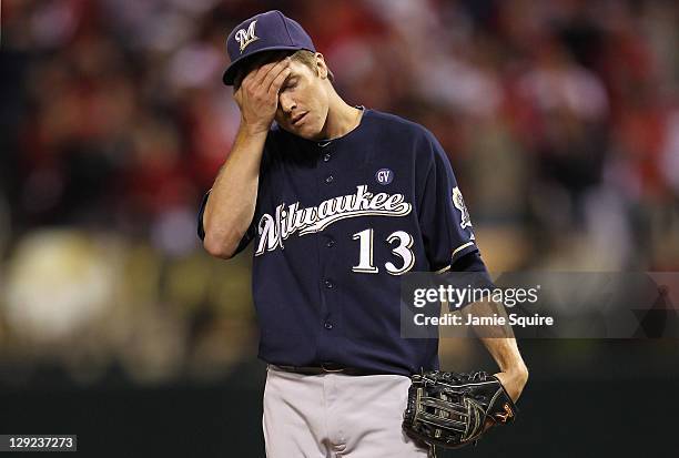 Zack Greinke of the Milwaukee Brewers reacts after Matt Holliday of the St. Louis Cardinals reaches on an infield single in the bottom of the fifth...