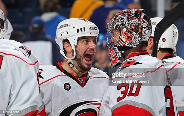 Chad LaRose of the Carolina Hurricanes celebrates with goaltender Cam Ward after their 4-3 victory over the Buffalo Sabres at First Niagara Center on...