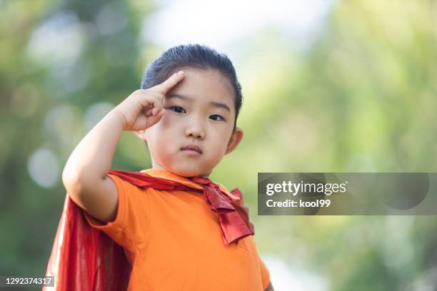 supergirl saluting - child saluting stock-fotos und bilder