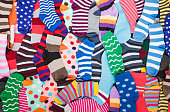 Different multicolored bright socks. Abstract background image.
