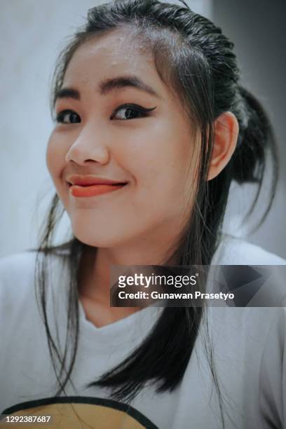 indonesian women are in independent isolation after being exposed to the covid-19 virus and remain cheerful - beautiful perfection exposed lady stock pictures, royalty-free photos & images