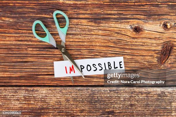 scissor cutting impossible text - adversity word stock pictures, royalty-free photos & images