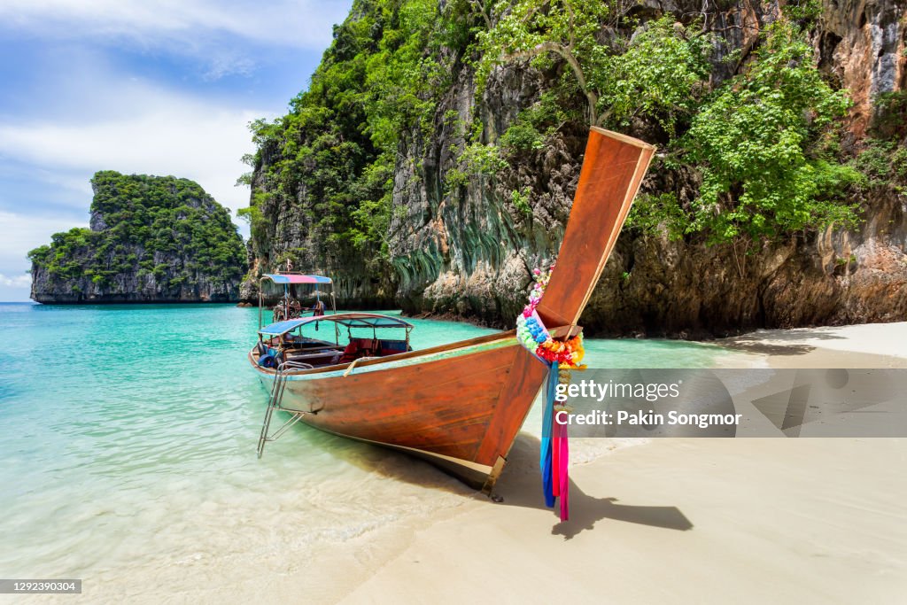 Traditional longtail boat with beautiful scenery view at Pileh Lagoon - Phi Phi Leh Island in sunshine day.