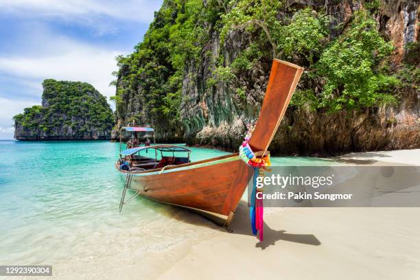 traditional longtail boat with beautiful scenery view at pileh lagoon - phi phi leh island in sunshine day. - lagoon stock pictures, royalty-free photos & images