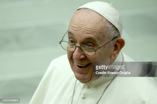 Pope Francis greets faithful as he leaves the Paul VI Hall at the end of an audience with Vatican employees for Christmas greetings on December 21,...