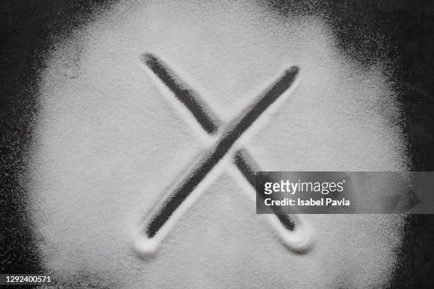 x shape made on sugar background - letter x stock-fotos und bilder