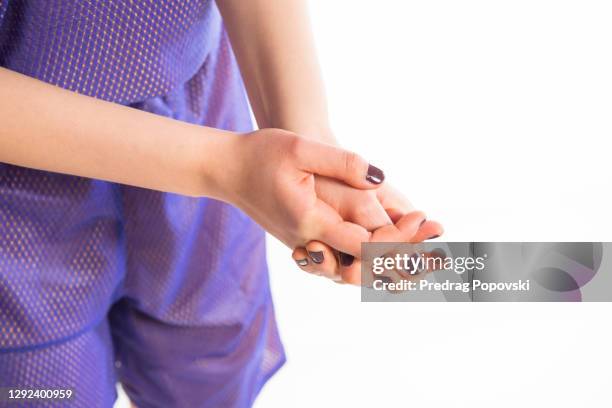 young female with pain in her hands isolated on white background - hand massage stock pictures, royalty-free photos & images