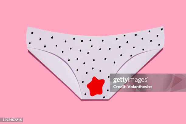women's panties stained with menstrual blood, free bleeding on pink background - blood love stock-fotos und bilder