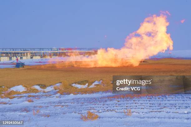 Flames come out from an exploratory well, with an estimated hundred-billion-cubic-meter natural gas and oil reserves, operated by China National...