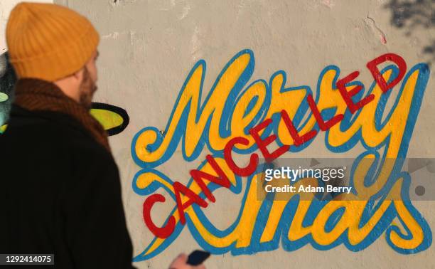 Graffiti proclaiming the cancellation of Christmas, featuring the Dr. Seuss Grinch character, is seen on a section of the former Berlin Wall amidst a...