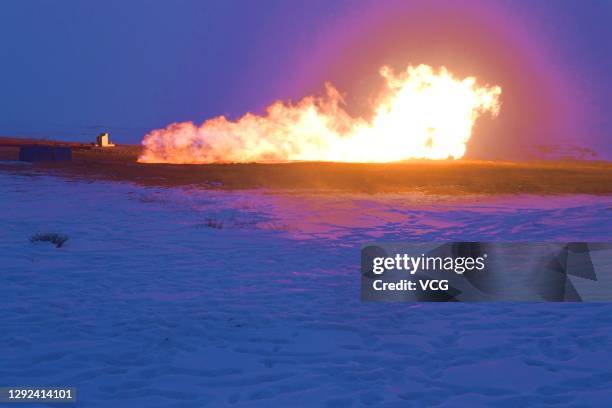 Flames come out from an exploratory well, with an estimated hundred-billion-cubic-meter natural gas and oil reserves, operated by China National...