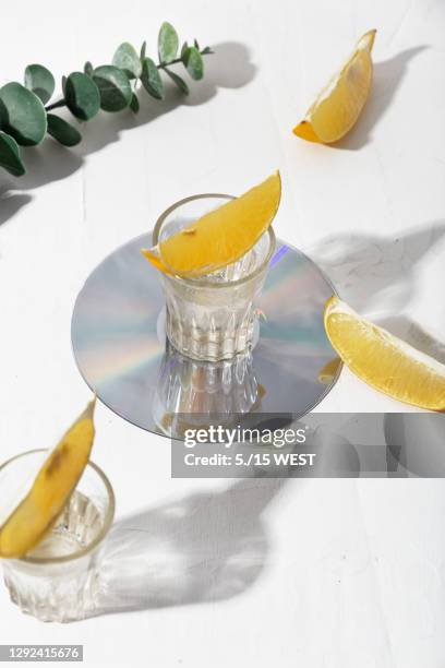 vodka shot glass and citrus on white background. still life - vodka stock pictures, royalty-free photos & images