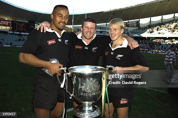 Jonah Lomu , Sean Fitzpatrick and Jeff Wilson of New Zealand hold the Bledisloe Cup after winning the Final against Australia in Sydney, Australia....