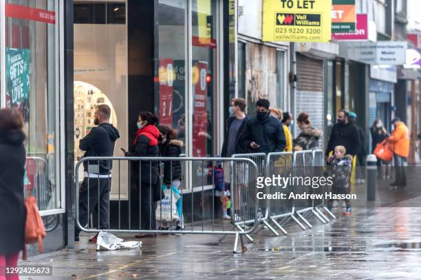 Shoppers queueing outside Argos on Commercial Road on December 21, 2020 in Portsmouth, United Kingdom. A new strain of the Covid-19 virus has led to...